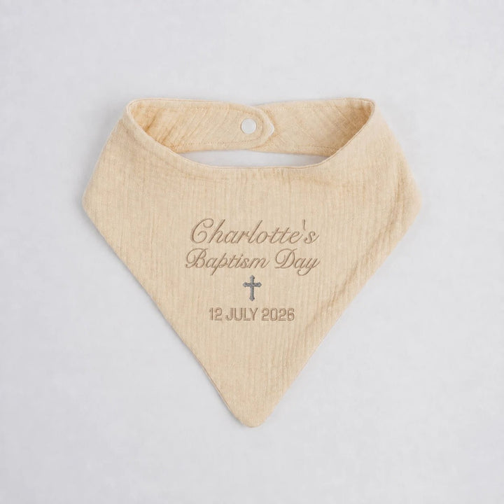 Personalised beige baptism baby bib with embroidered name Charlotte, cross and baptism date
