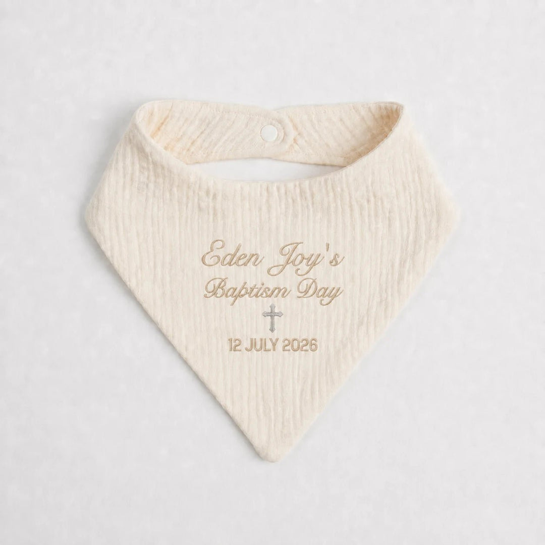 Personalised cream baptism baby bib with embroidered name Eden Joy, cross and baptism date
