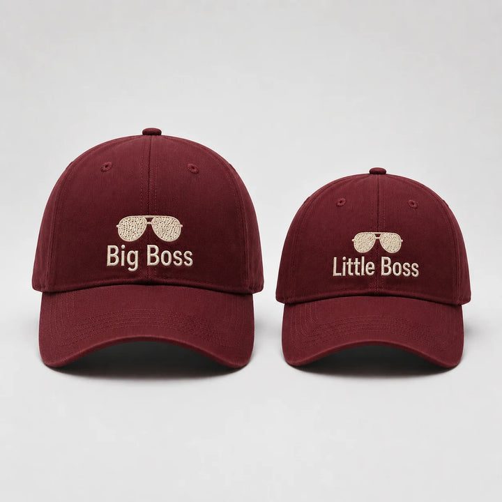 Two maroon caps with 'Big Boss' and 'Little Boss' text on a light gray background