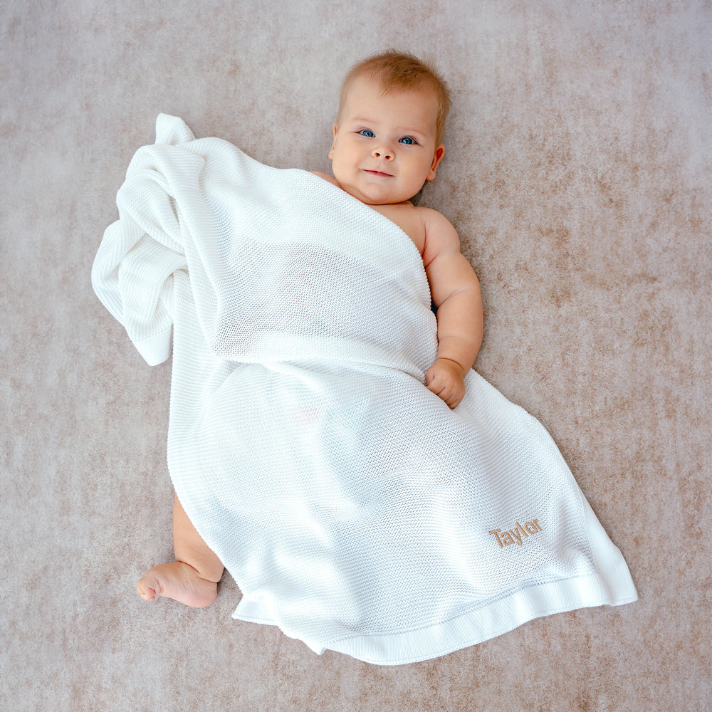 Baby covering with White Bamboo Blanket with "Taylor" customised in Beige thread