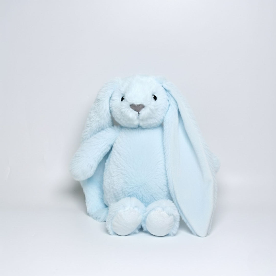 Light blue plush bunny toy on a light gray background