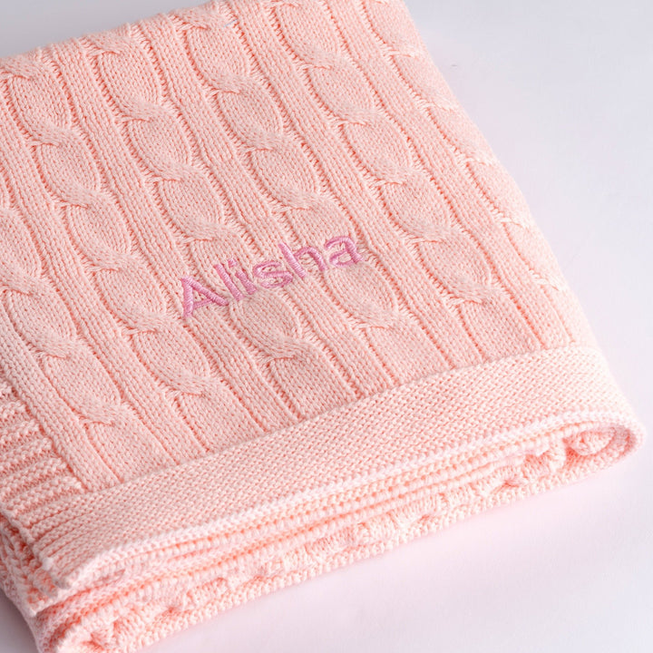 Pink cable knit blanket with "Alisha" personalised in pink thread