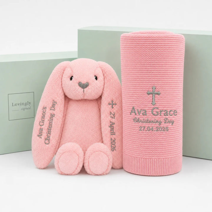 Personalised pink christening gift set with a pink bunny soft toy and matching embroidered pink blanket, displayed with Lovingly Signed gift boxes.