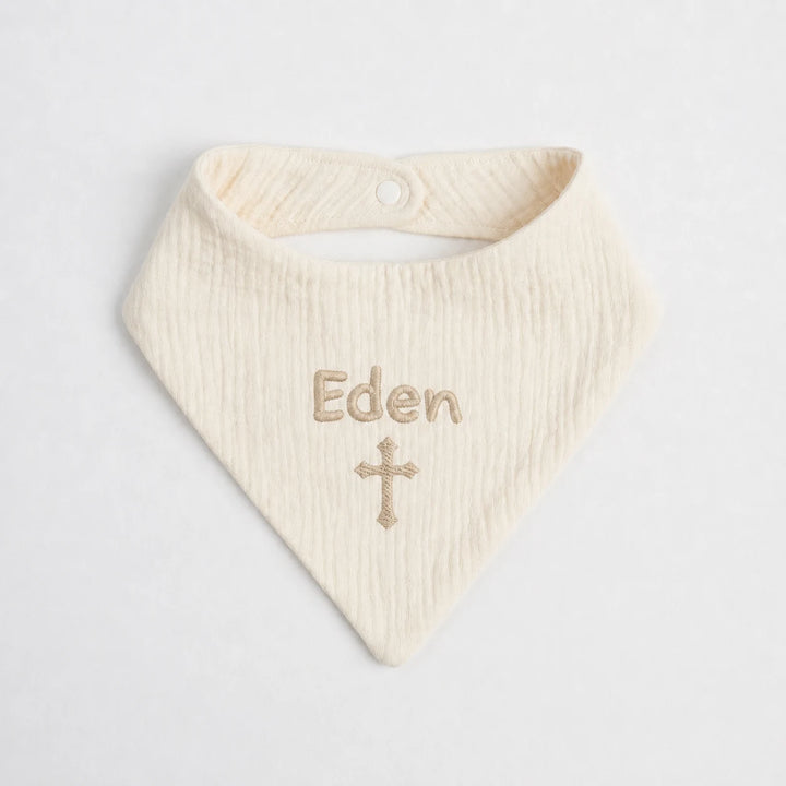 Personalised cream Christian baby bib with embroidered name Eden and cross