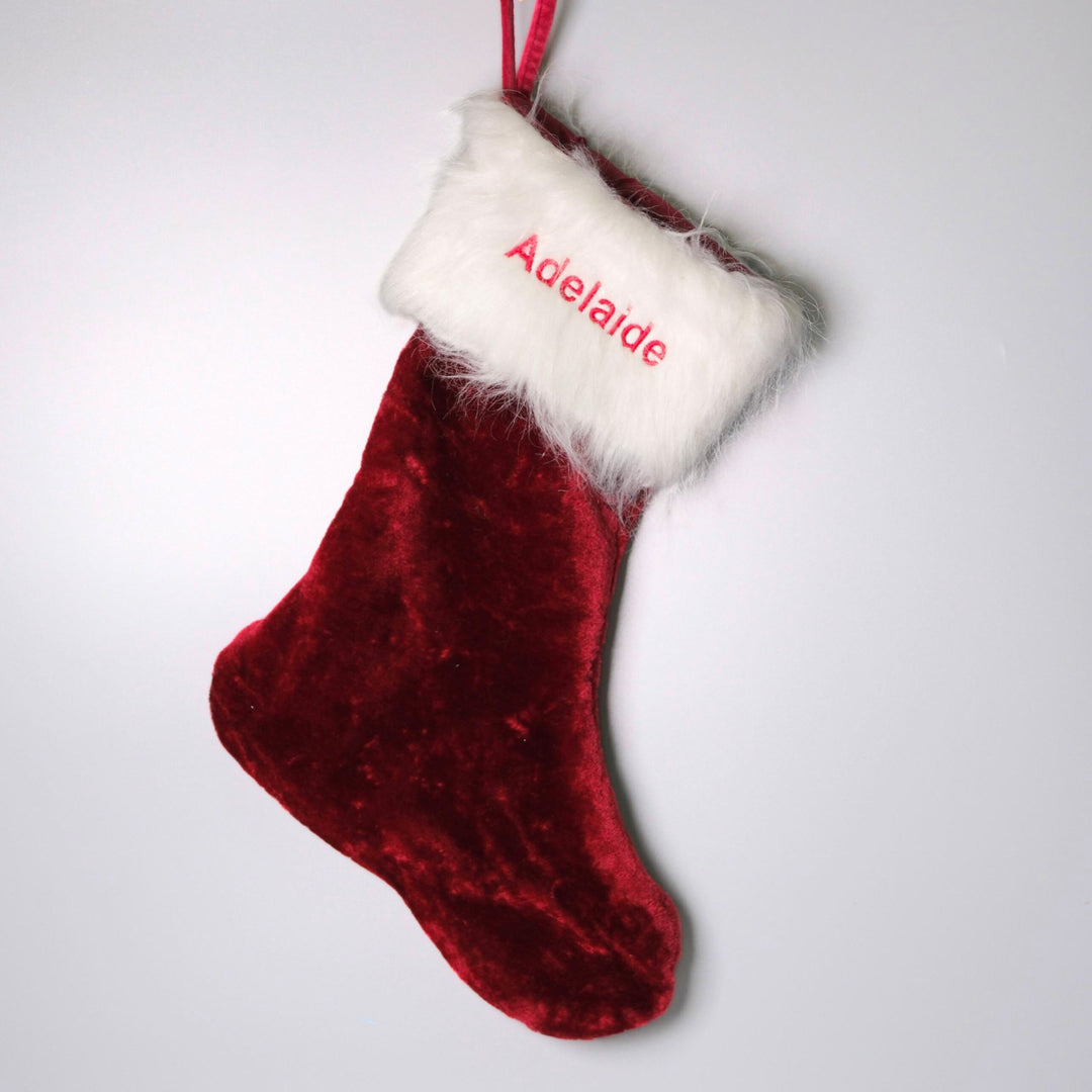 Red velvet christmas stocking personalised with "Adelaide" in red thread