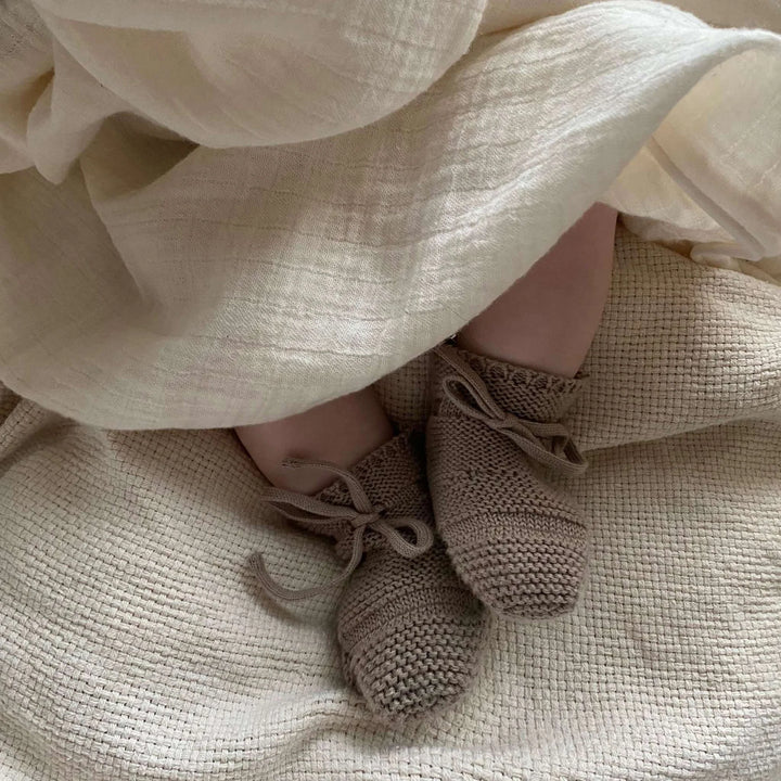 Close up of baby wearing Cosy Roots Organic Knit Booties - Caramel