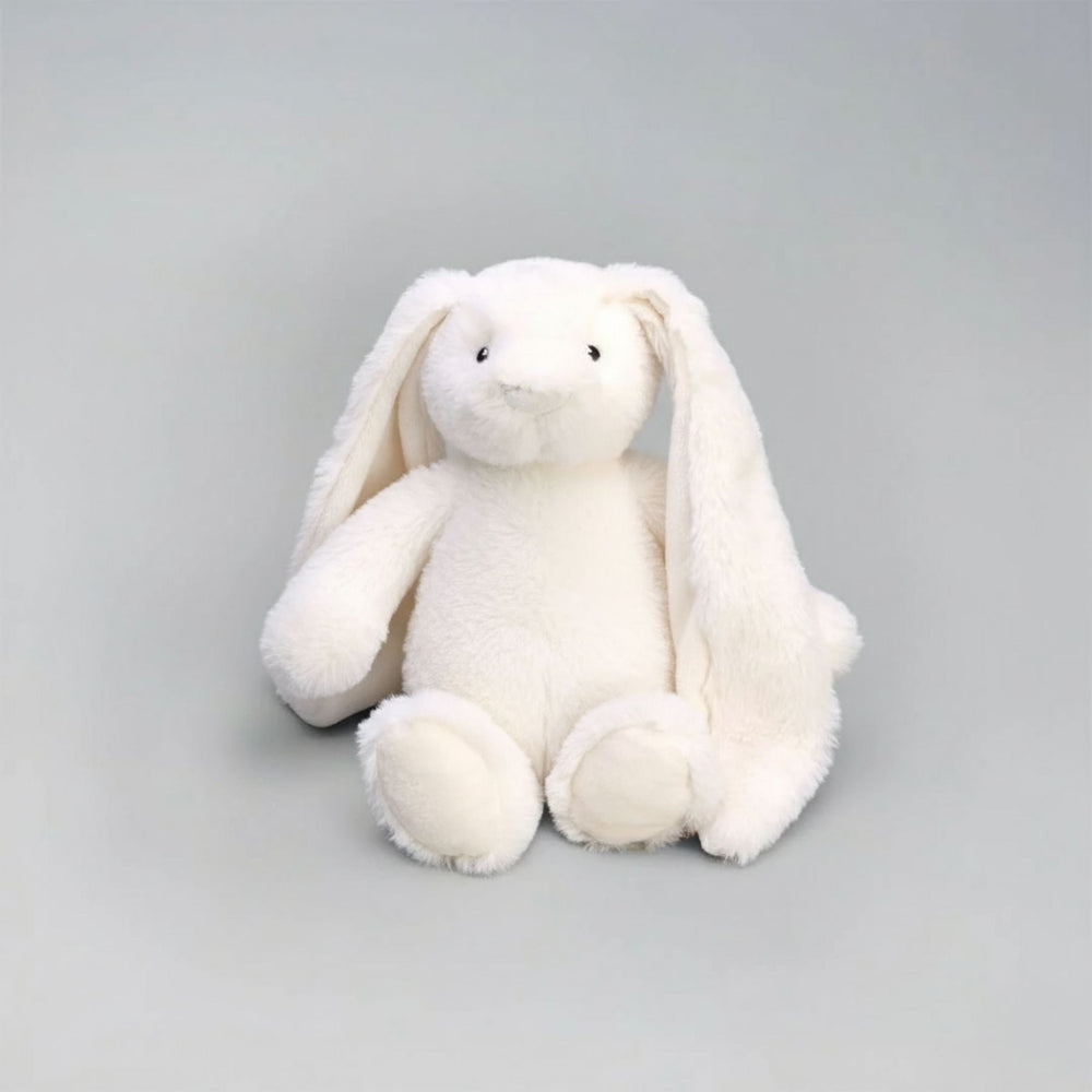 White plush bunny toy on a gray background