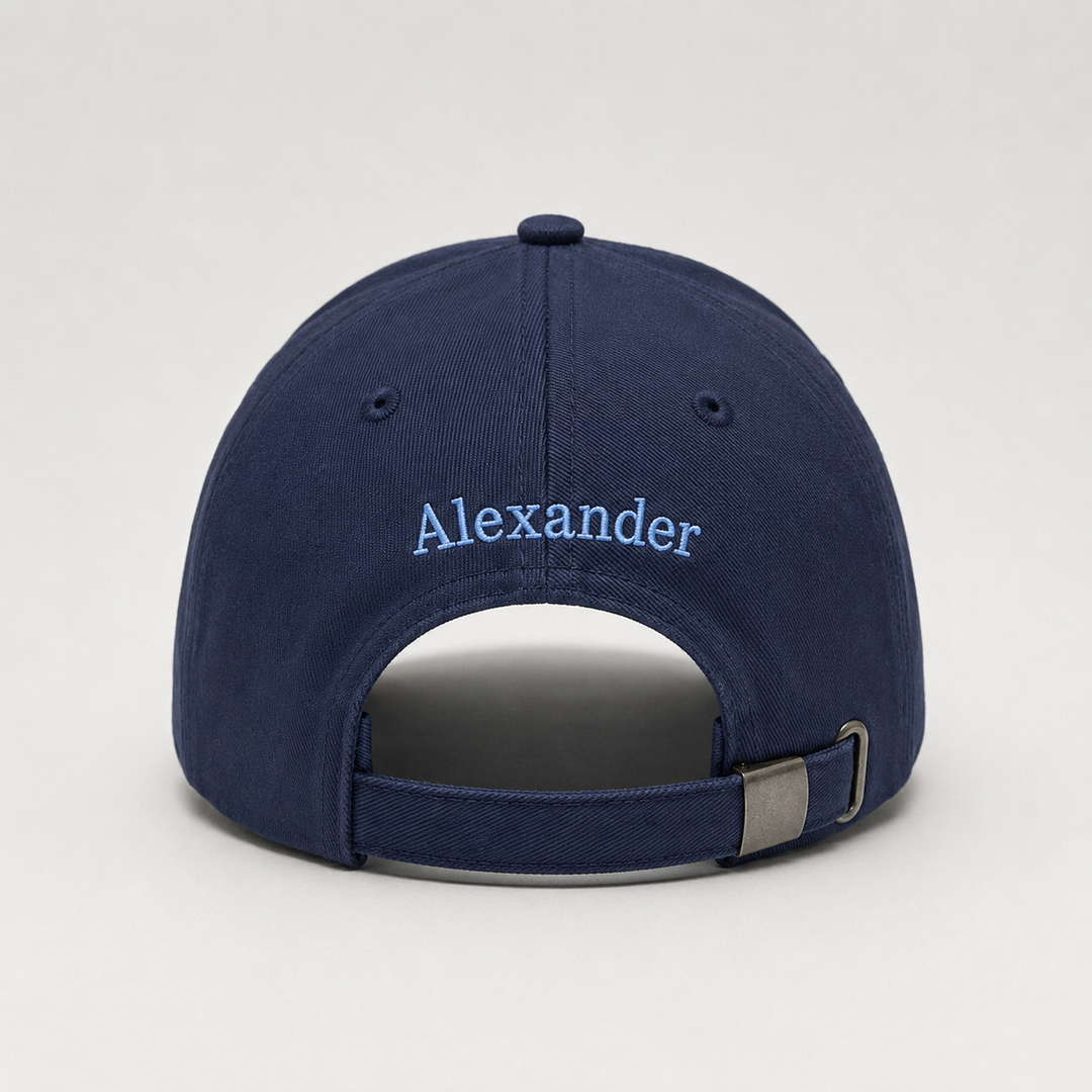 Navy blue cap with 'Alexander' embroidered on the back against a light gray background
