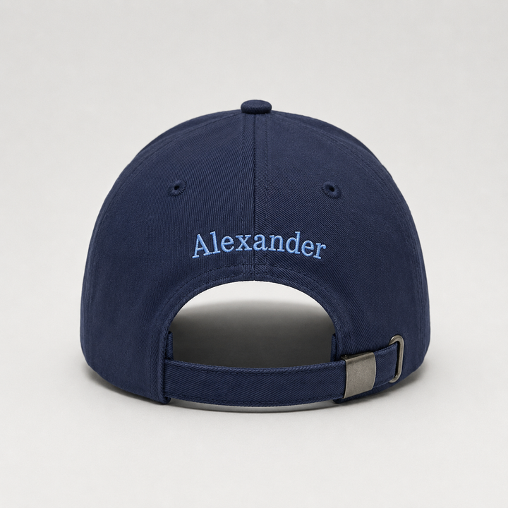 Navy blue cap with 'Alexander' embroidered on the back against a light gray background