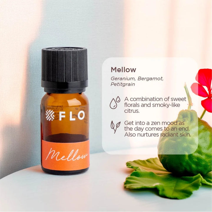 Flo Aroma Mellow essential oil blend with geranium, bergamot and petitgrain, displayed beside a floral arrangement with product benefits shown.