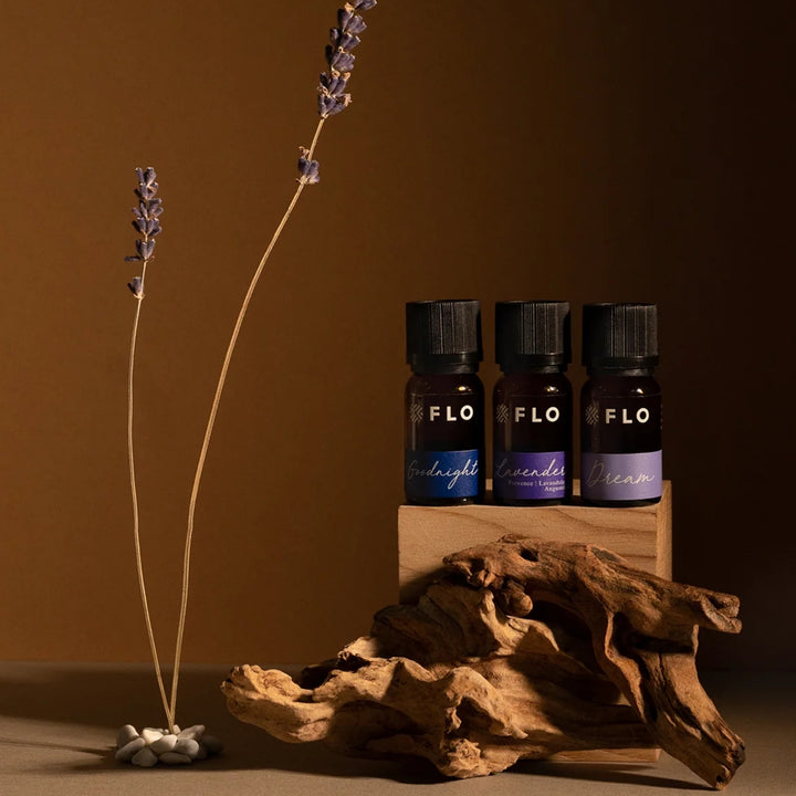 Flo Aroma essential oil collection featuring Goodnight, Lavender and Dream blends styled with dried lavender and natural wood decor.