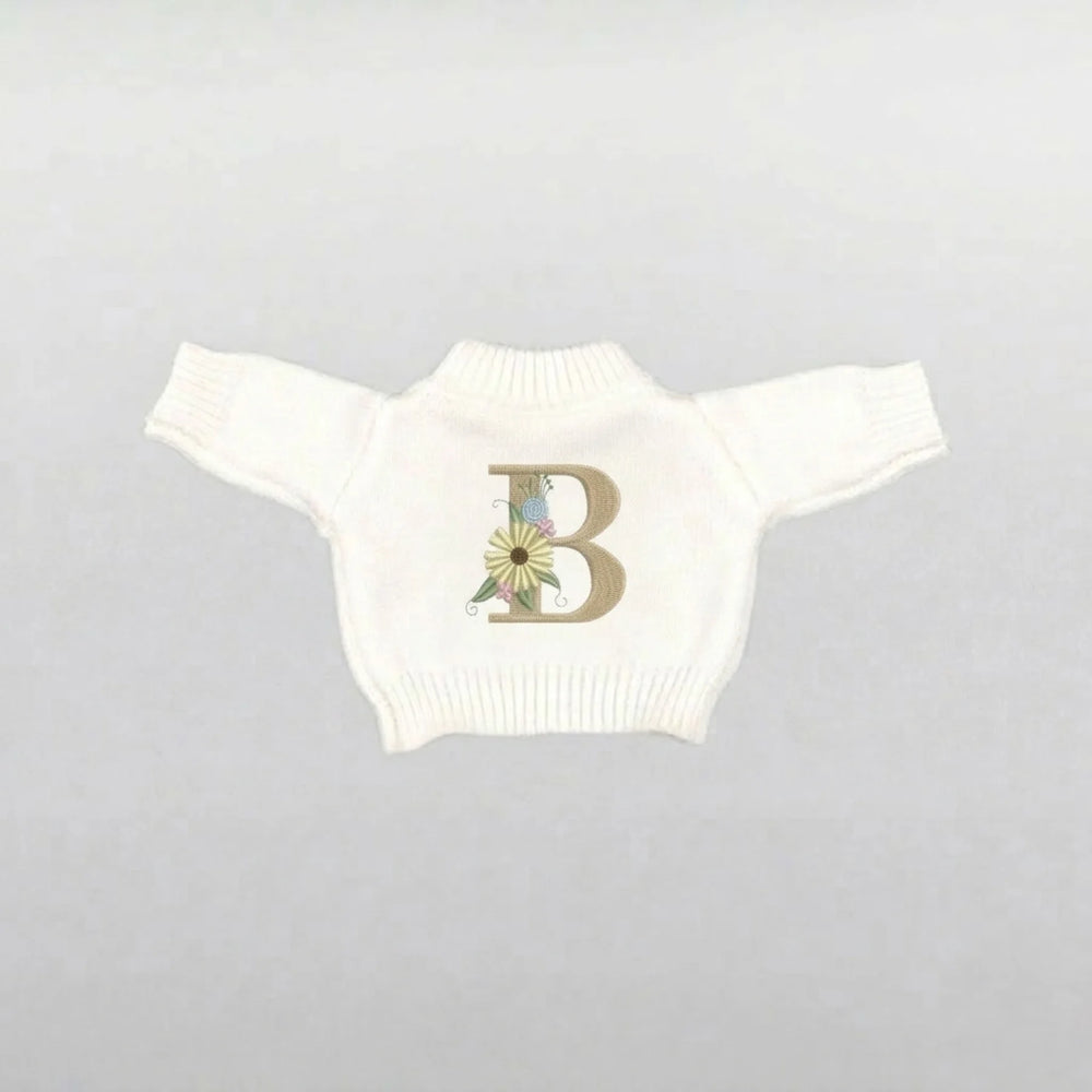 Cream plushie sweater with a floral letter 'B' design 
