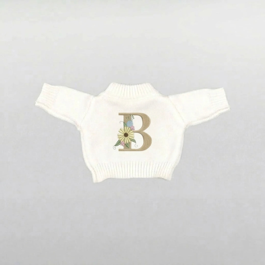 Cream plushie sweater with a floral letter 'B' design 