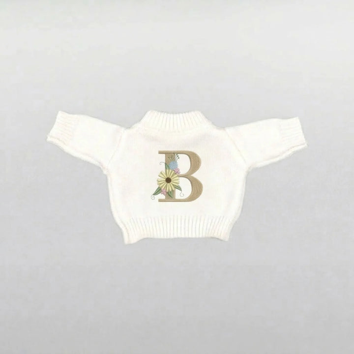 Cream plushie sweater with a floral letter 'B' design 