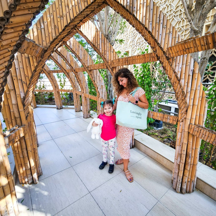 Mother and daughter carring Lovingly Signed Luxurious gift bag