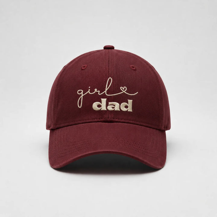 Maroon cap with 'girl dad' text on a white background