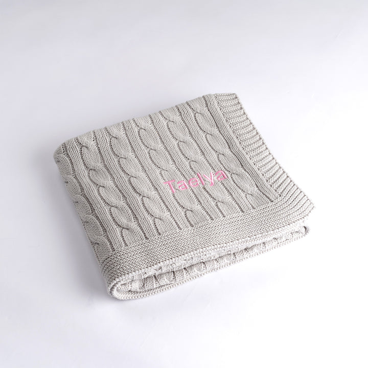 Grey Cable Knit Blanket personalised with "Taelya" in Pink 
