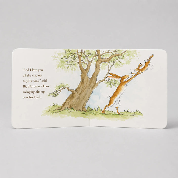 Illustrated book page with a tree and two animals on a gray background