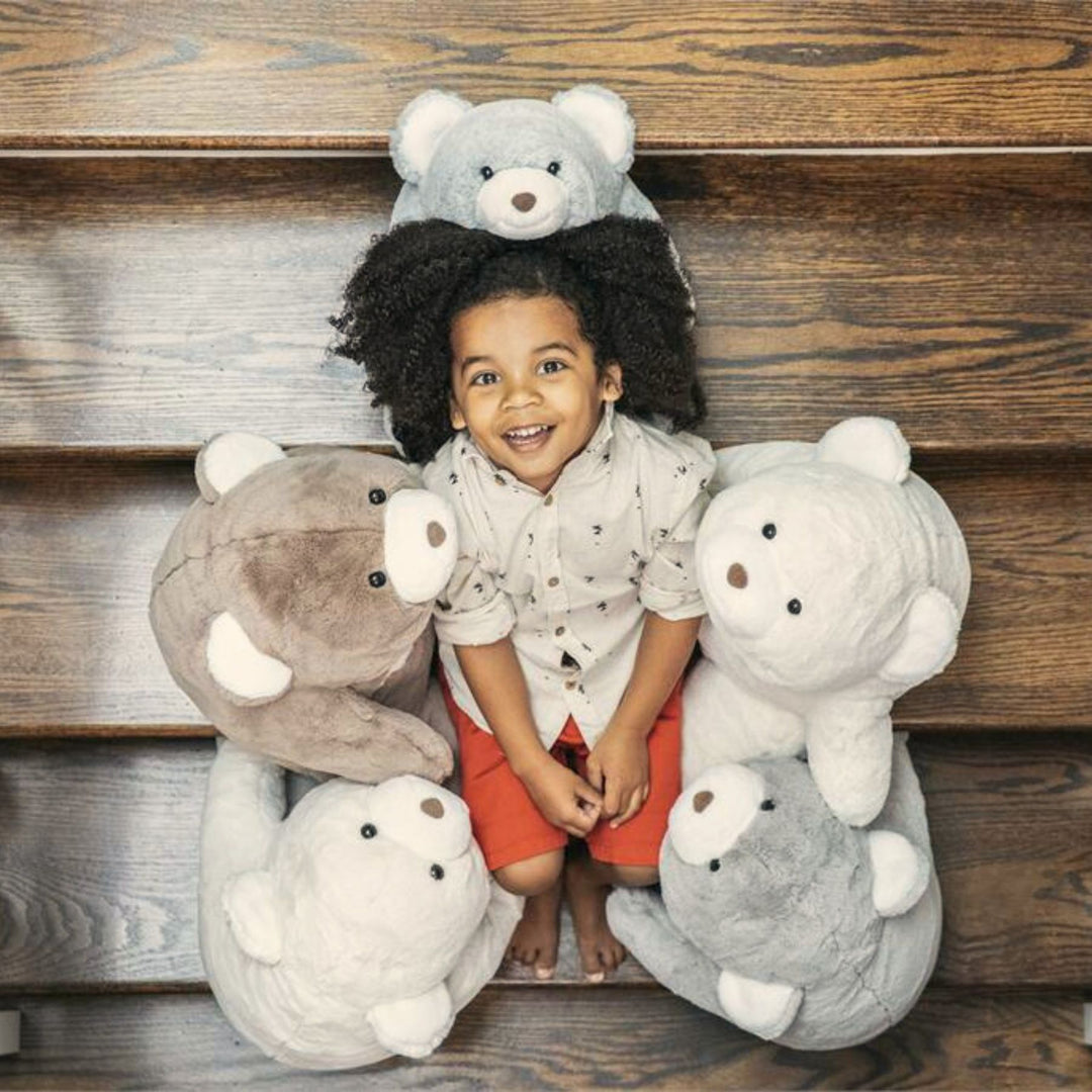 Child surrounded by Gund Snuffles 
