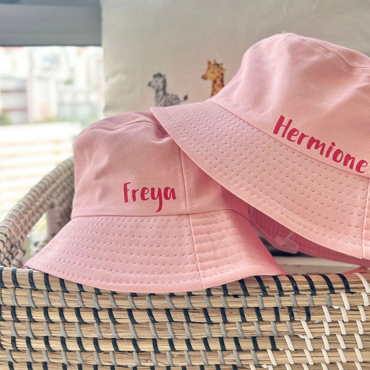 Hast By Fly Bucket Hat in Pink personalised with "Freya" and "Hermione" in Red