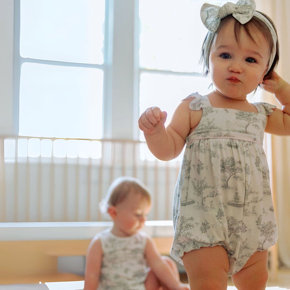 Toddled wearing House of Holly Garden Toile Ruffle Bubble Romper in Silver