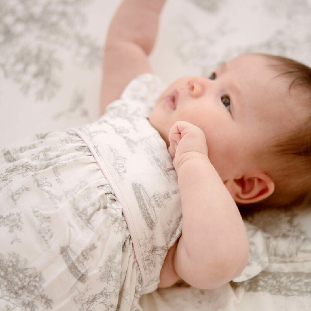 Baby wearing House of Holly Garden Toile Ruffle Bubble Romper in Silver