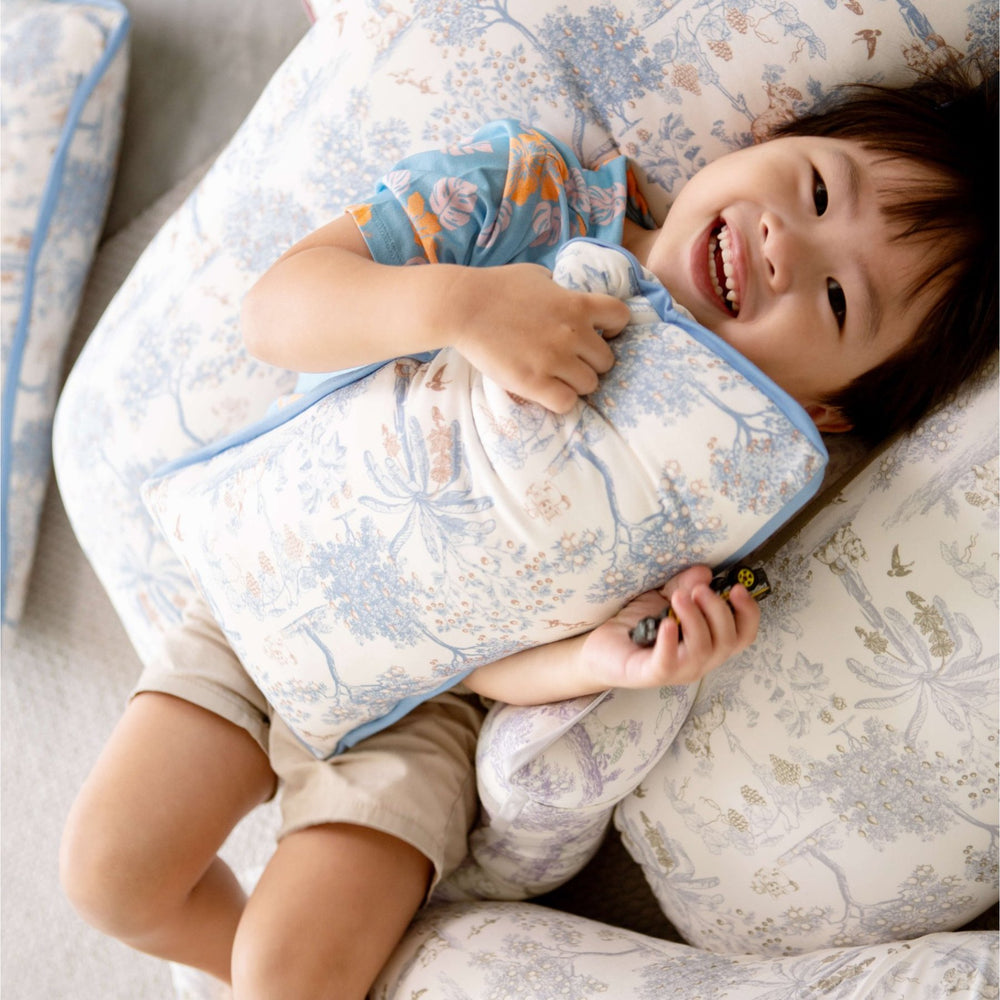 Boy cuddling with House of Holly Luxe Cloud Pillow – Fruit Toile (Blueberry)