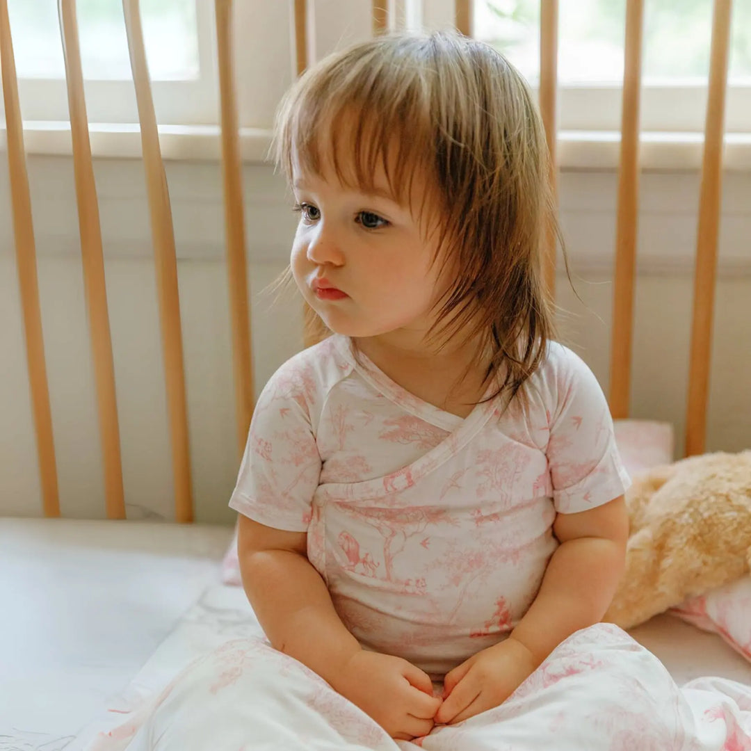 Wrap-style baby bodysuit in breathable bamboo fabric