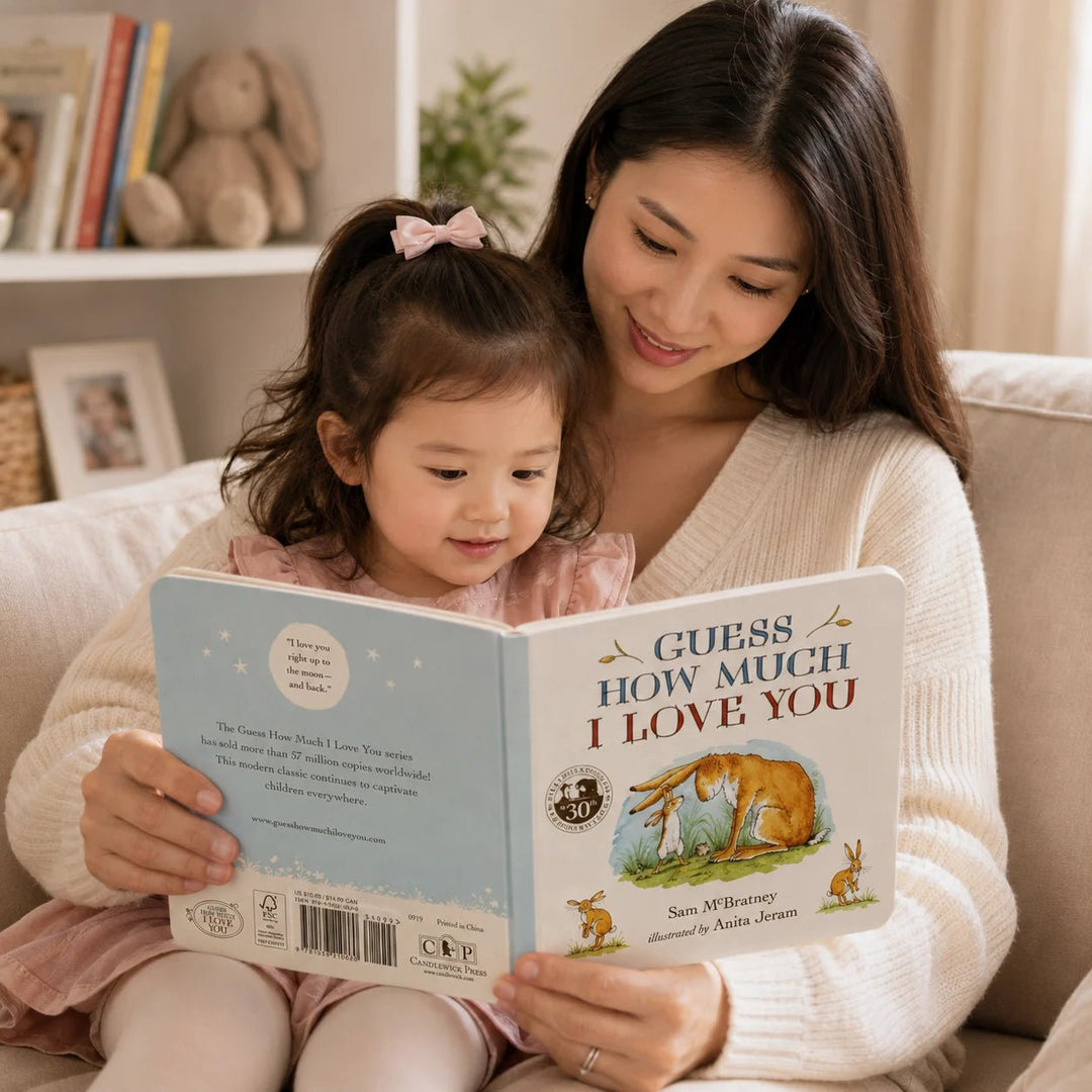 Mother  and child reading 'Guess How Much I Love You' book together.