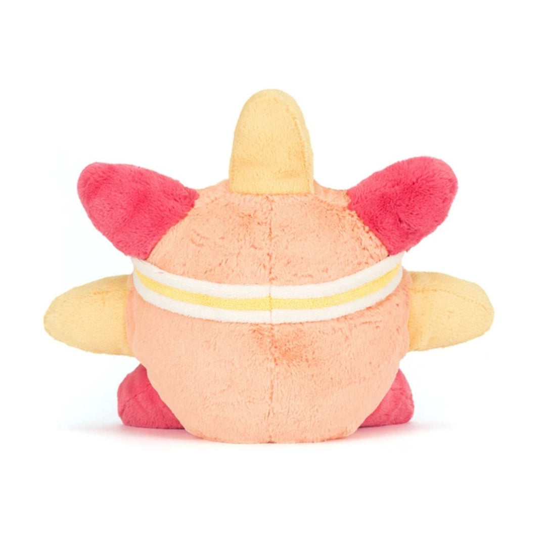 Back view of the peach and yellow roller-skating sun soft toy, showing the striped sweatband, bright pink side details and yellow arms.