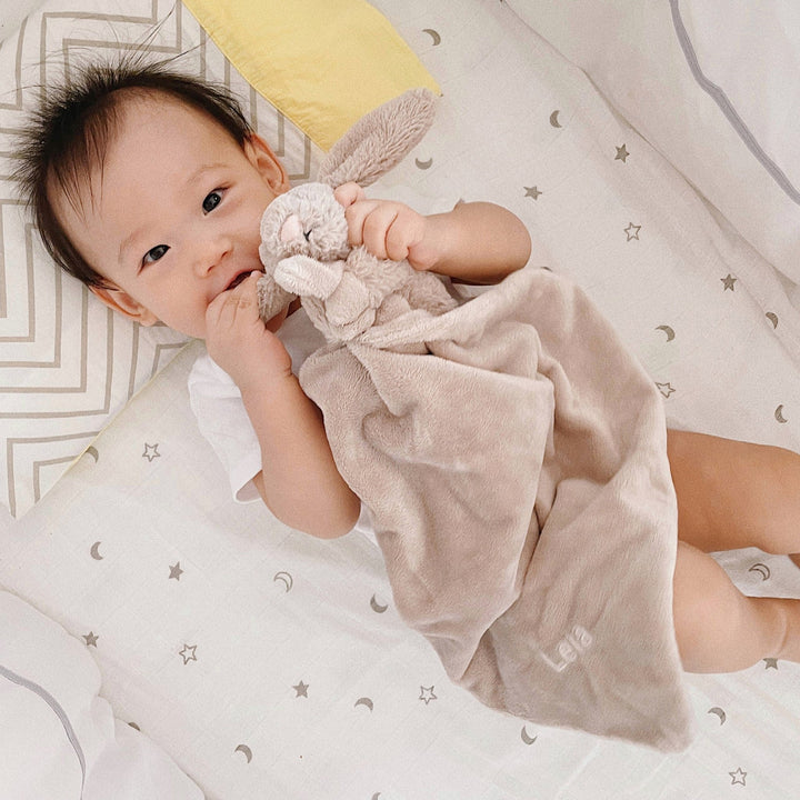 Baby cuddling with Jellycat Bashful Beige Bunny Soother