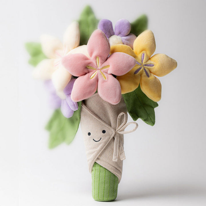 Jellycat Amuseables Bouquet of Flowers standing upright with a smiling fabric wrap, colourful plush flowers and green stem.
