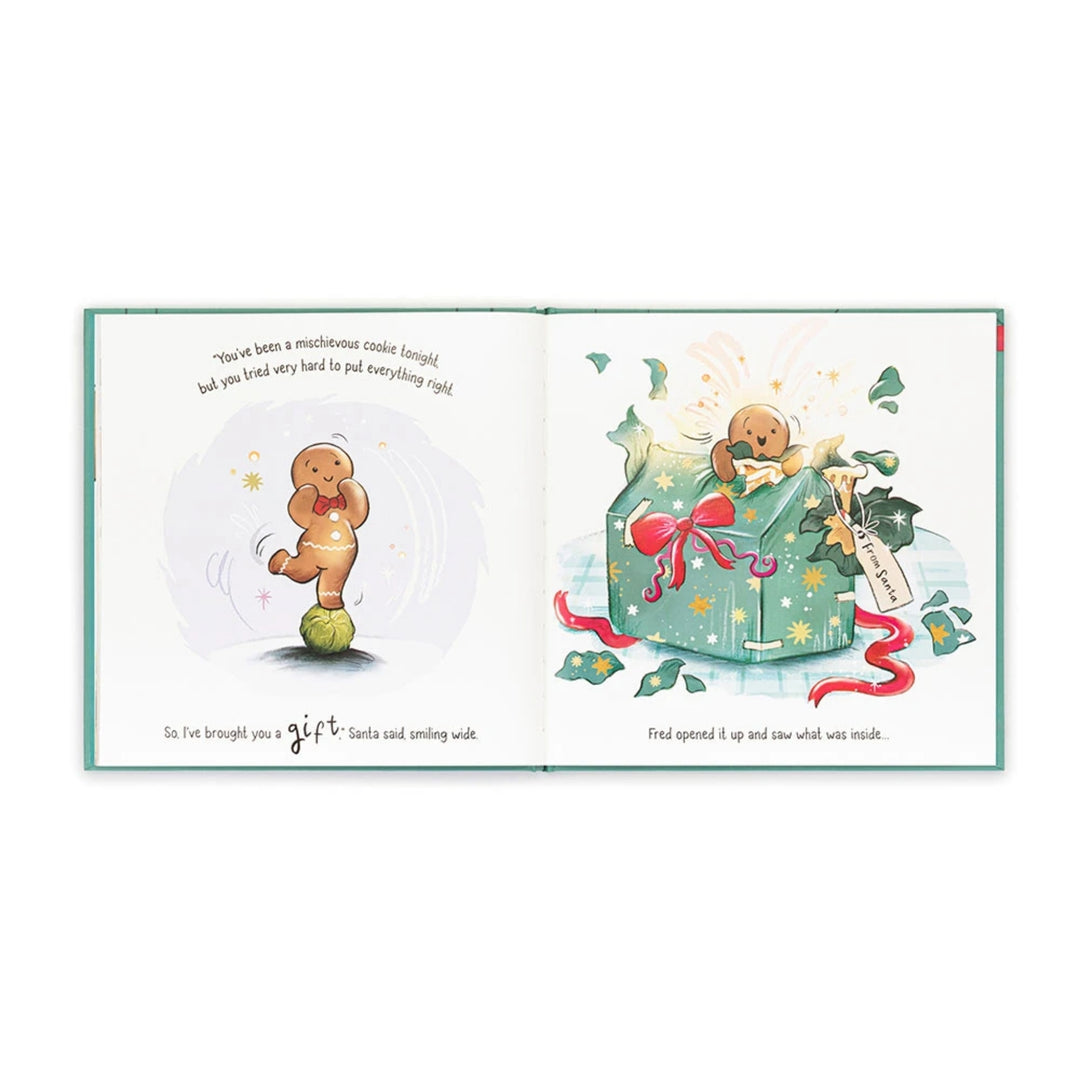 Open “Gingerbread Fred” Christmas picture book showing Fred balancing on a Brussels sprout before receiving a large festive gift from Santa.