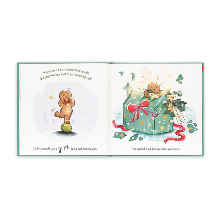Open “Gingerbread Fred” Christmas picture book showing Fred balancing on a Brussels sprout before receiving a large festive gift from Santa.