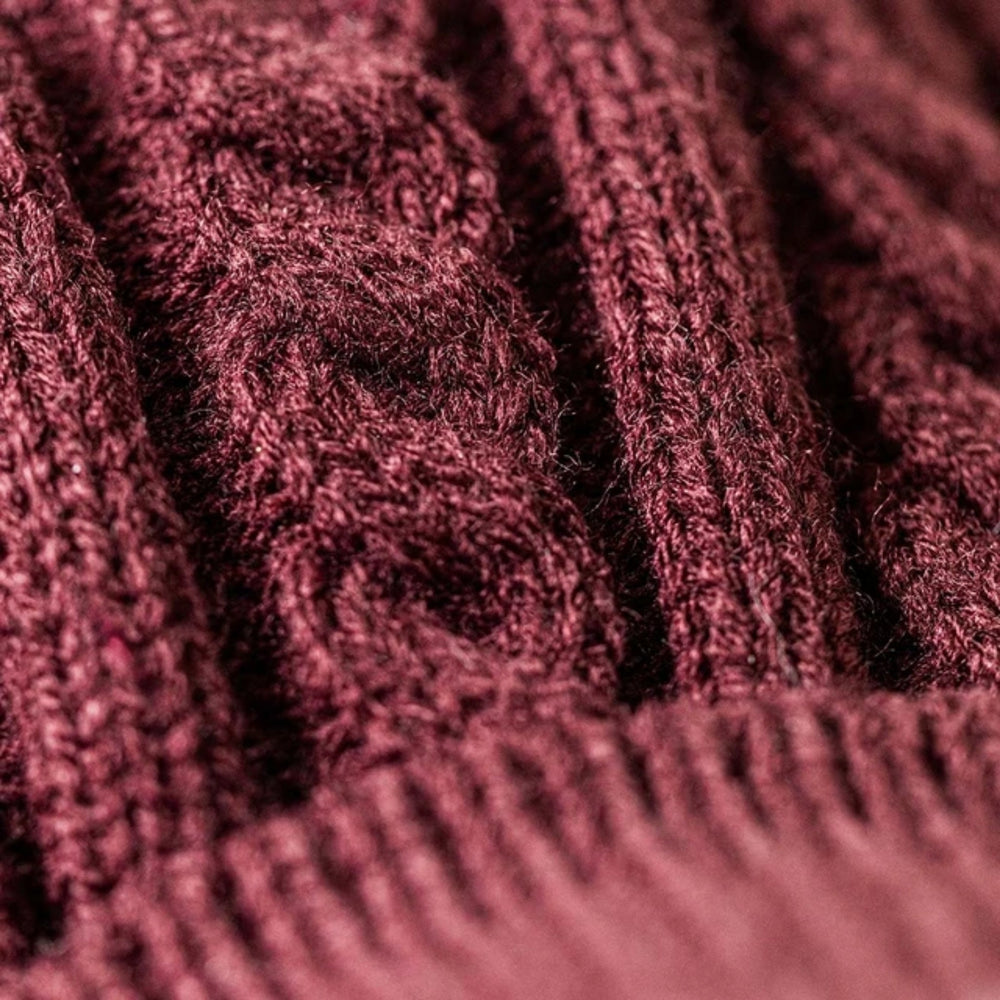 Close-up of the burgundy cable-knit jumper worn by Jellycat Munro Scottie Dog, highlighting the intricate knitted pattern and soft fabric texture.