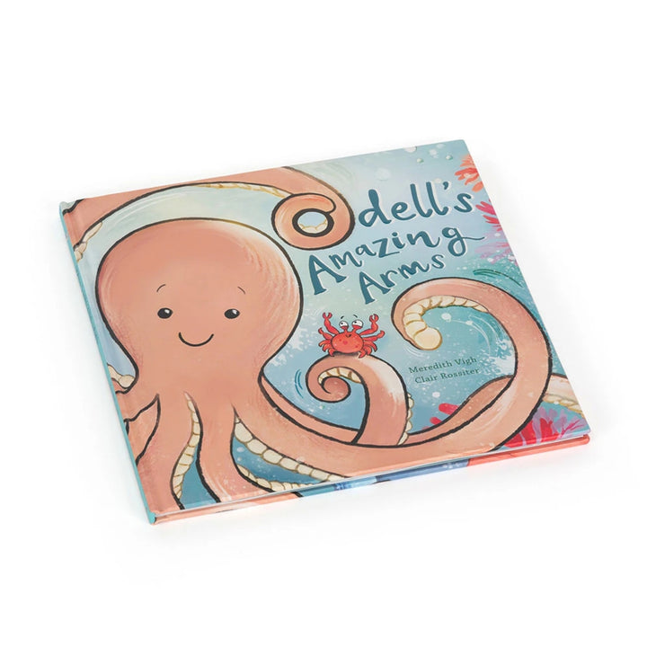 “Odell’s Amazing Arms” children’s picture book shown at an angle, featuring a smiling peach-coloured octopus on the illustrated cover.