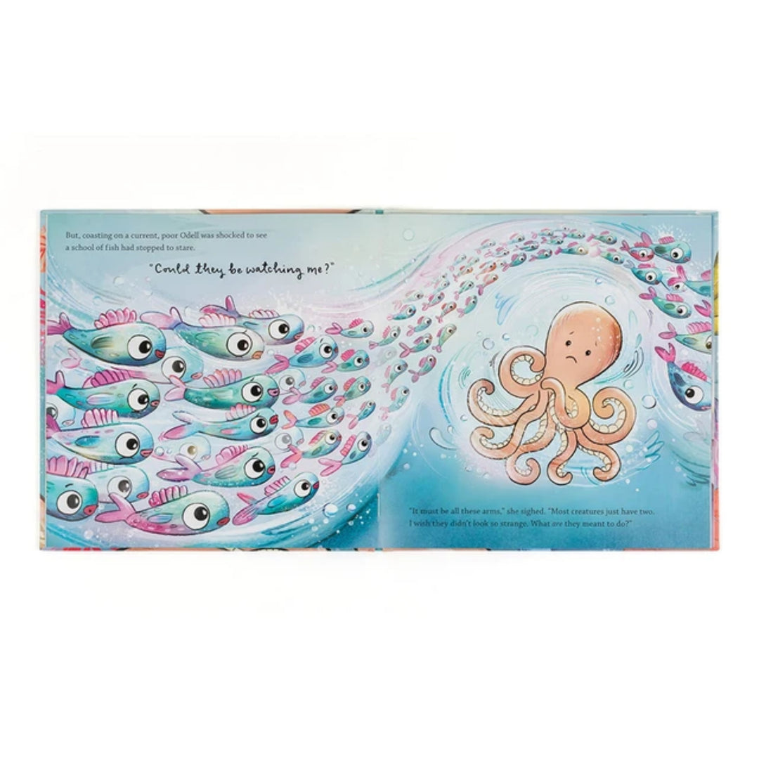 Open children’s book spread showing Odell surrounded by a school of colourful fish in an underwater scene.