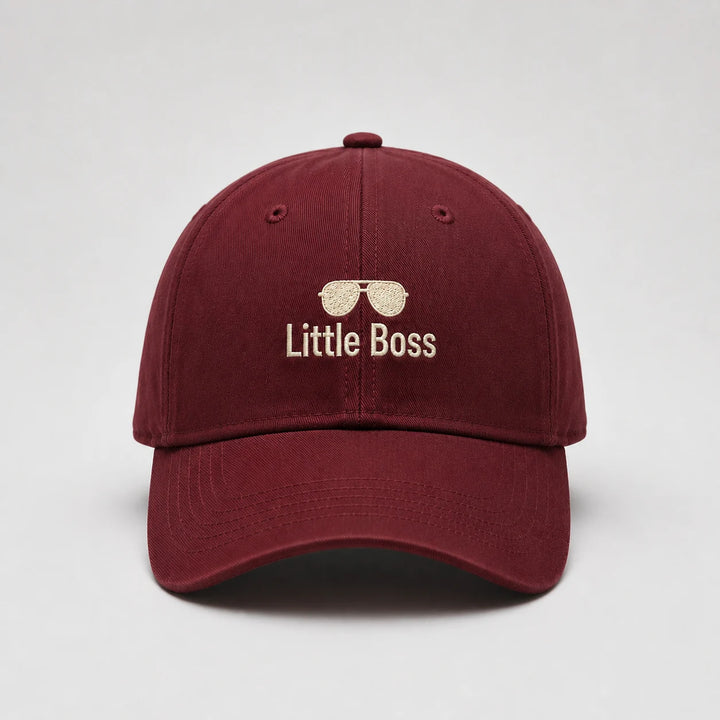 Maroon cap with 'Little Boss' text and sunglasses icon on a light gray background