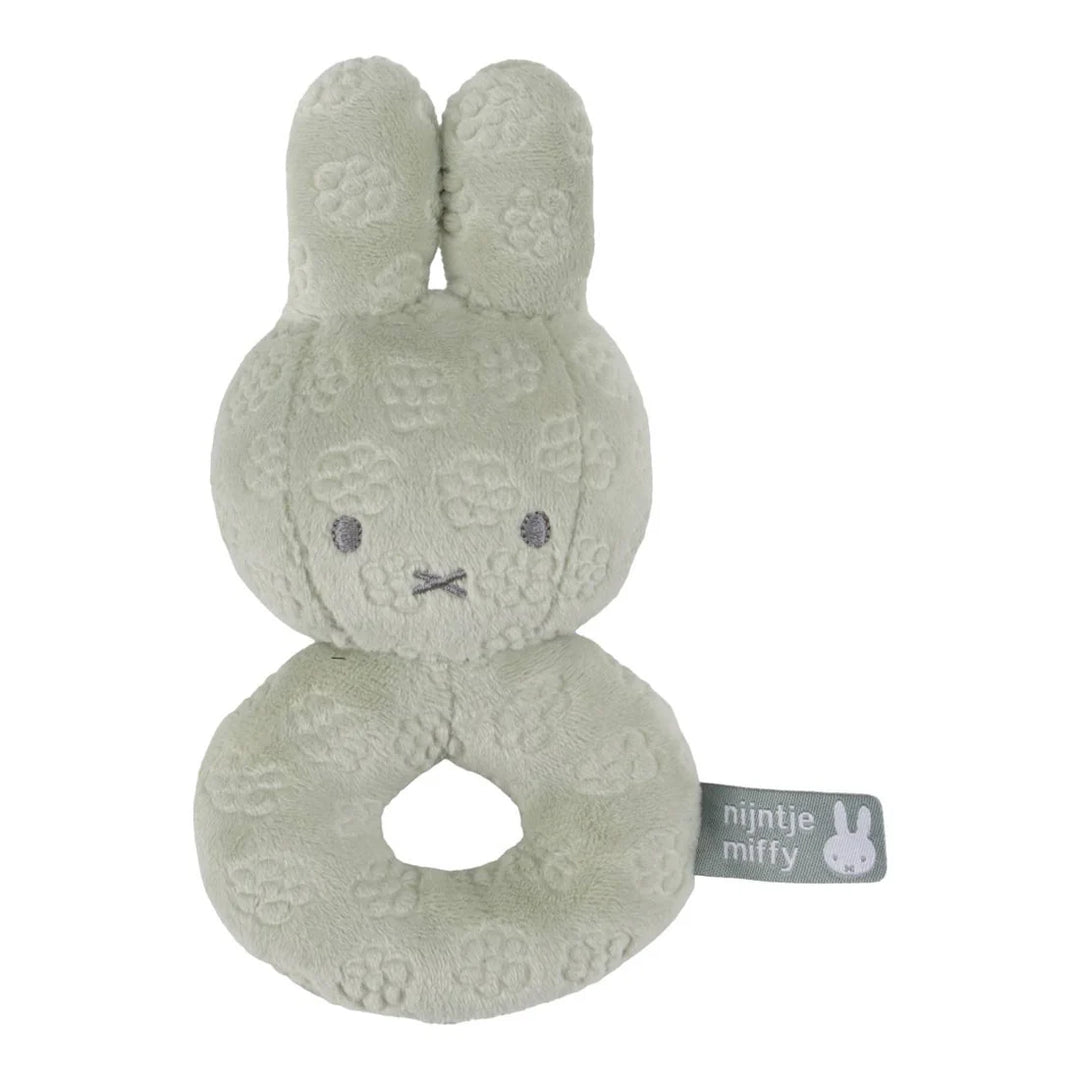 Green plush toy with a ring and 'nijntje miffy' tag on a white background