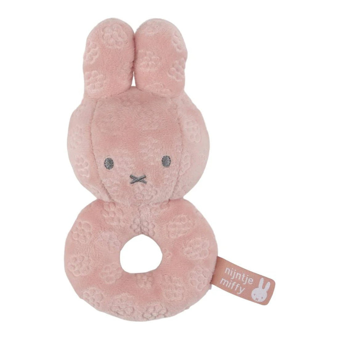 Pink plush bunny rattle with 'nijntje miffy' tag on a white background