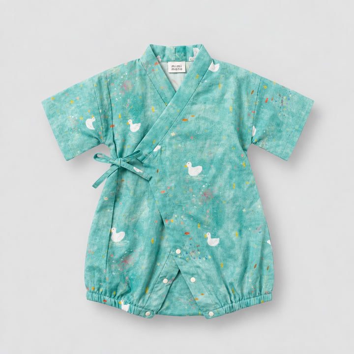 Teal kimono-style baby romper with white duck prints, colourful pond-inspired details, wrap-front tie and short sleeves.