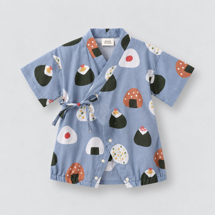 Light blue kimono-style baby romper with colourful onigiri rice ball prints, wrap-front tie detail, short sleeves and snap closures.