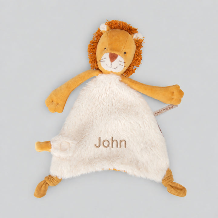 Personalised Moulin Roty Mamba Lion comforter with mustard lion details, cream plush fabric and the name “John” embroidered on the front.