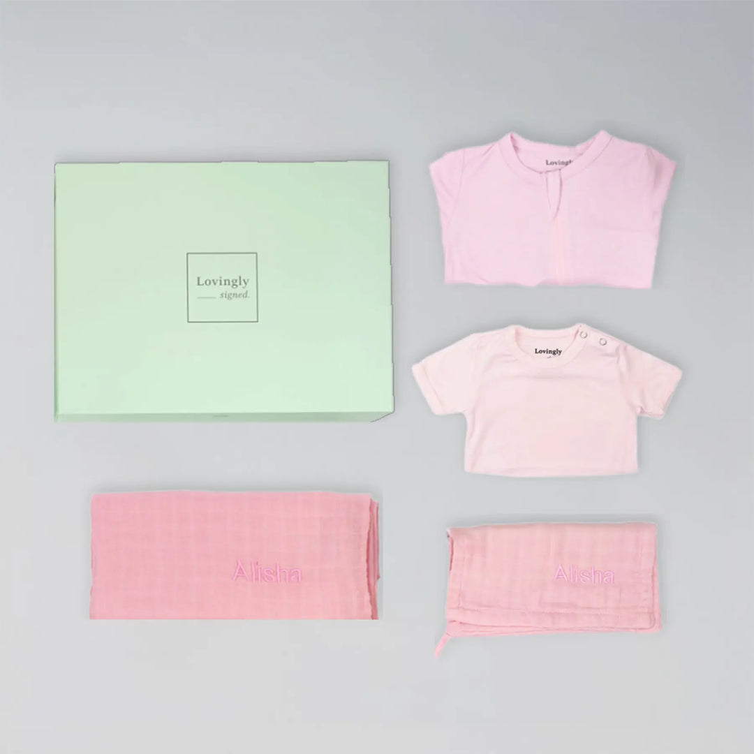 Luxury pink bamboo baby gift set including swaddle, wash cloth, babygrow and bodysuit