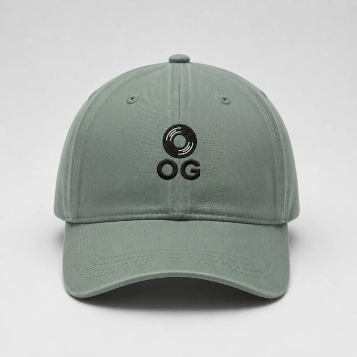 Green cap with black logo on a light gray background