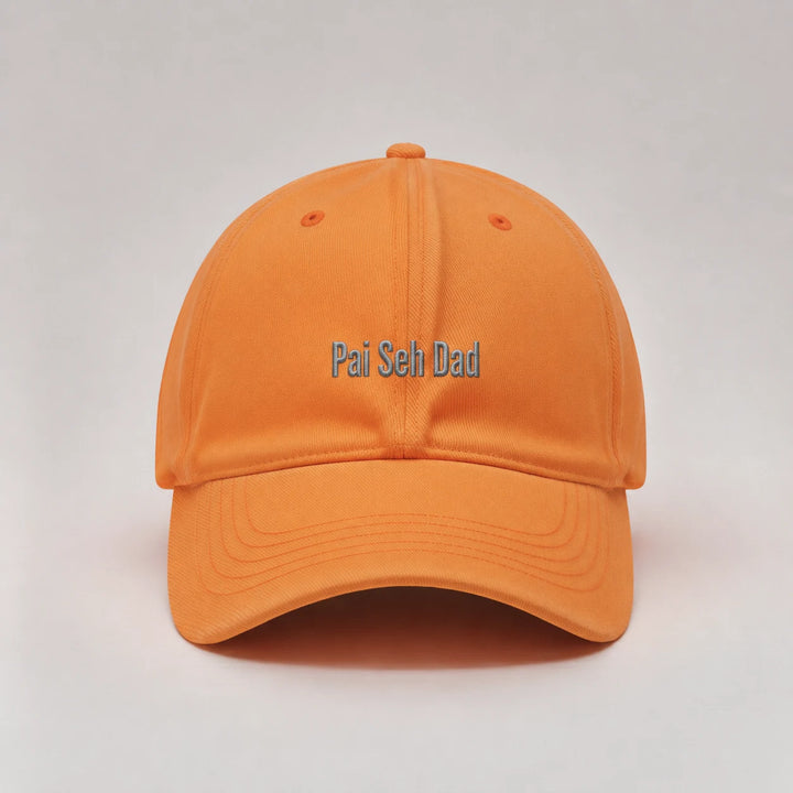 Orange cap with 'Pai Seh Dad' text on a light gray background