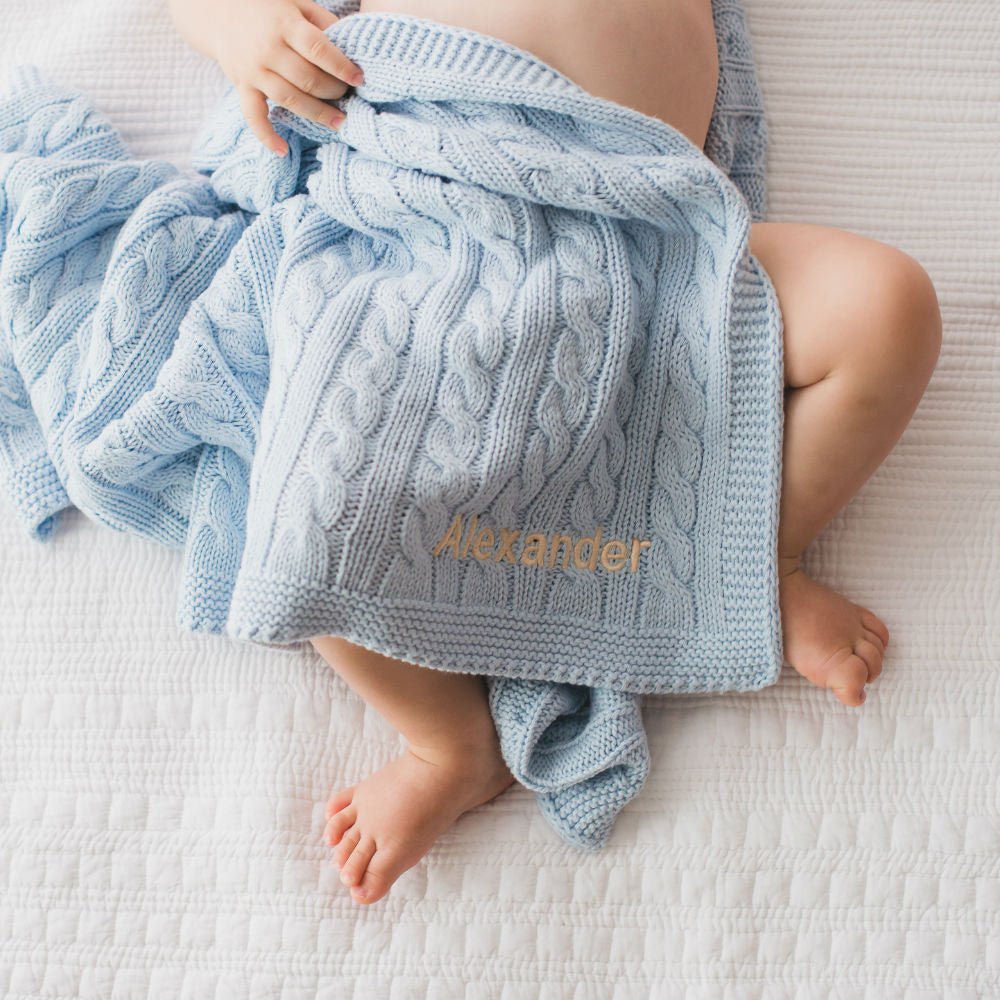 Create a unique keepsake with this personalized blue cable knit blanket. A luxurious gift for babies