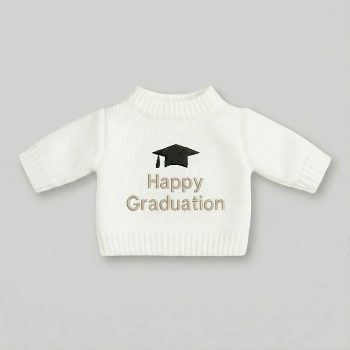 White sweater with 'Happy Graduation' text and graduation cap on a gray background