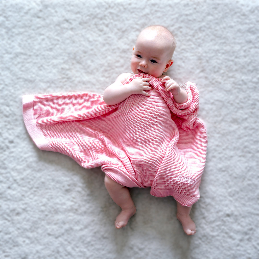 Baby covered in Pink Bamboo Blanket 