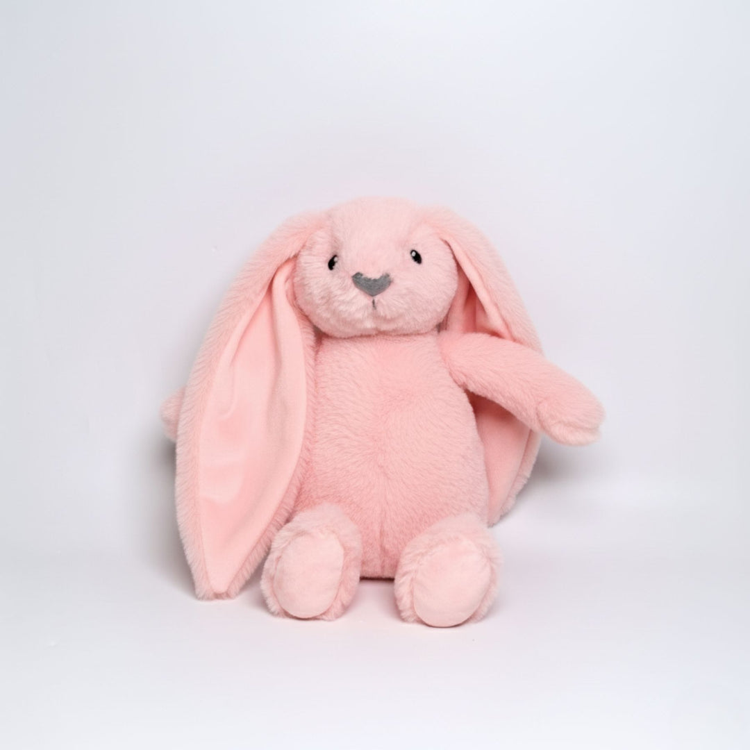 Pink plush bunny toy on a light gray background